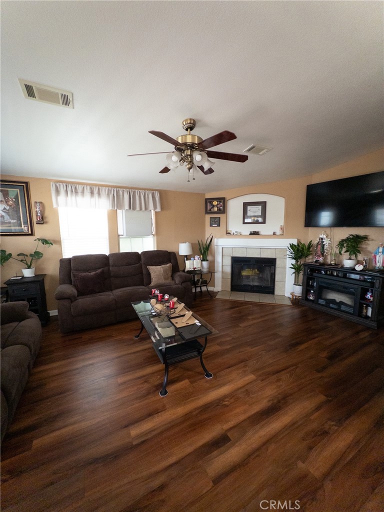 20843 Waalew Road Apple Valley, CA 92307 - Photo 29 of 32 a living room with furniture a fireplace and a flat screen tv