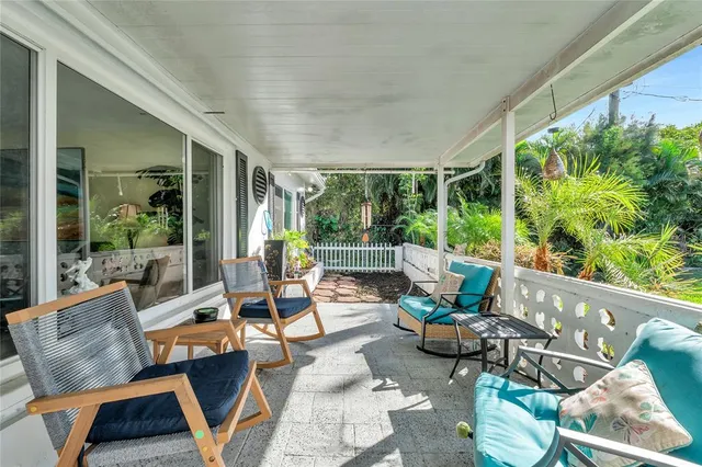 a view of a patio with couches chairs and potted plants