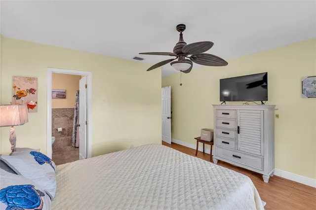 a bedroom with a bed and a tv