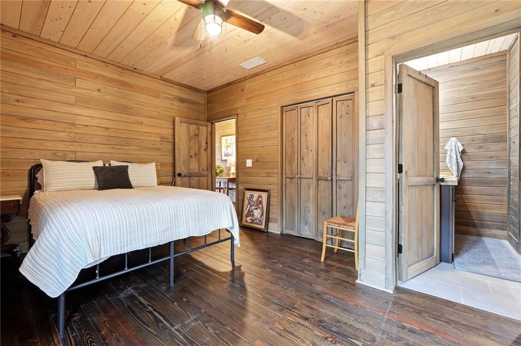 1041 Astro Court Northeast Ranger, GA 30734 - Photo 27 of 52 a bedroom with a bed lamps and a large window