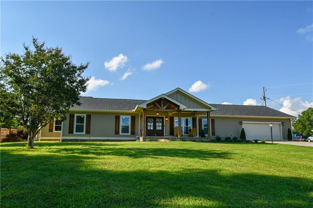 3878 Sloan Mill Road Gainesville, GA 30507 - Photo 1 of 1 a front view of a house with a garden