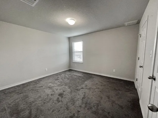 an empty room with a window and stairs