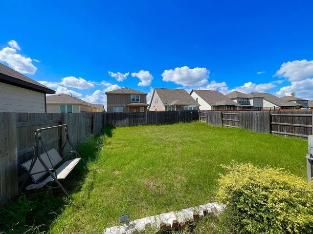 a view of a house with a backyard porch and sitting area