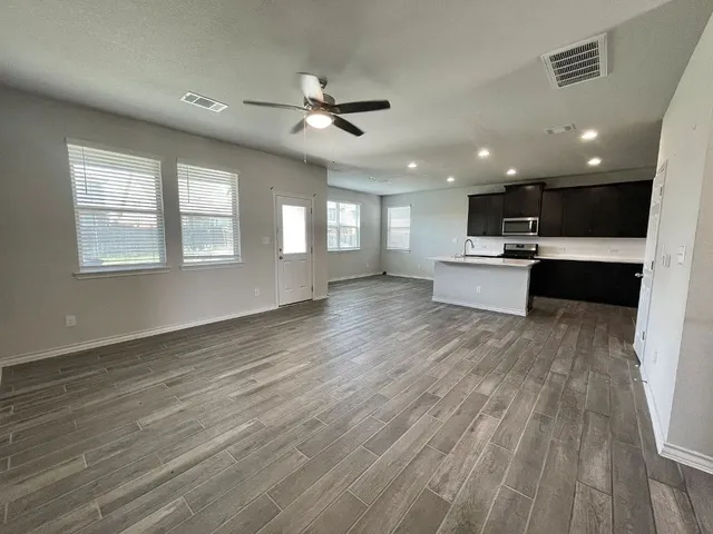 a view of a kitchen and windows