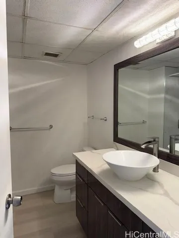 a bathroom with a sink a toilet and shower