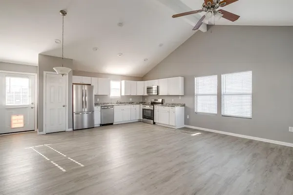 a view of a kitchen with a sink cabinets and wooden floor