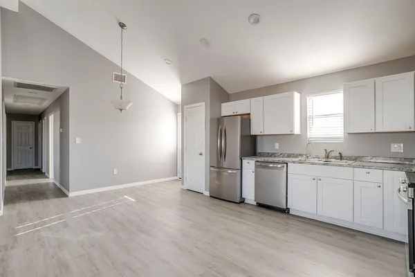 a kitchen with stainless steel appliances granite countertop a stove and a refrigerator