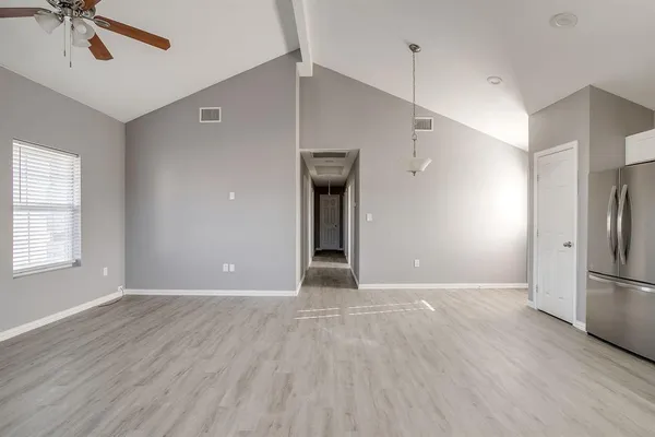 a view of a livingroom with wooden floor and a ceiling fan