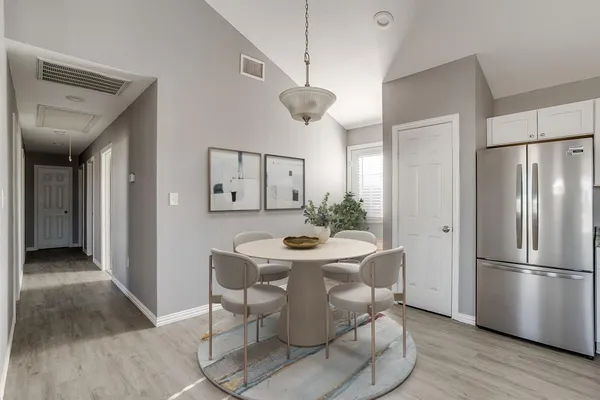 a dining room with furniture and wooden floor