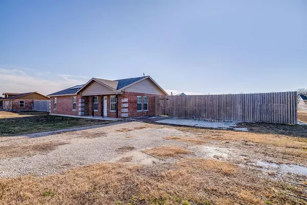 a front view of a house with wooden fence