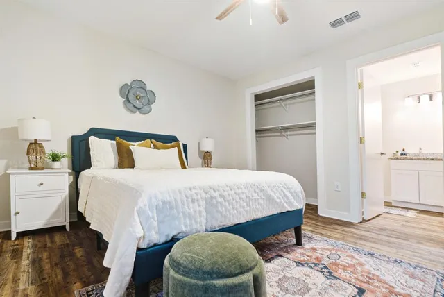 a bedroom with a bed and a lamp