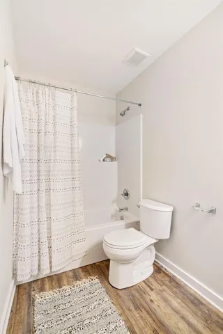 a bathroom with a toilet a sink and shower