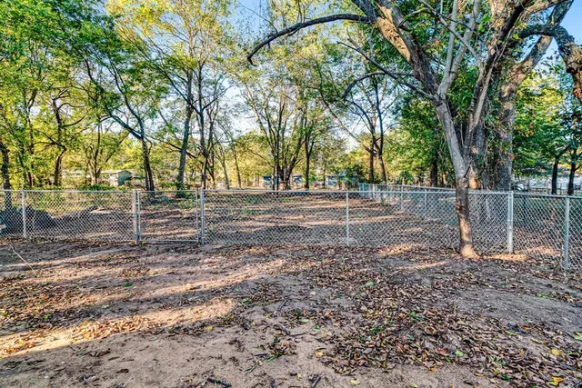 a backyard of a house with lots of trees