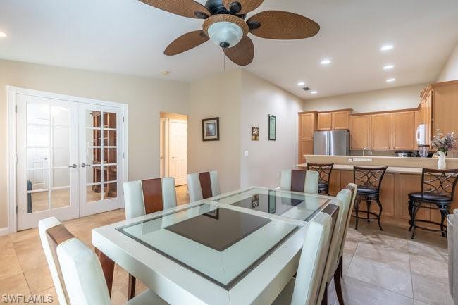 8623 Erice Court Naples, FL 34114 - Photo 13 of 37 a view of a a dining room with furniture window and wooden floor