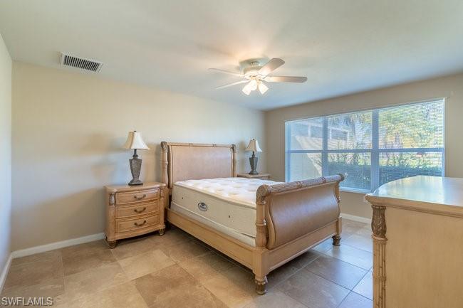 8623 Erice Court Naples, FL 34114 - Photo 18 of 37 a bedroom with a bed and window
