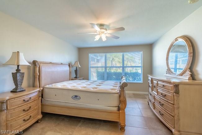 8623 Erice Court Naples, FL 34114 - Photo 19 of 37 a bedroom with a bed and a chandelier