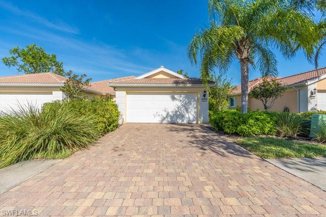 8623 Erice Court Naples, FL 34114 - Photo 2 of 37 a front view of a house with a yard