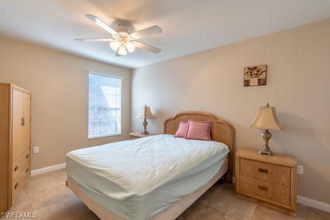 8623 Erice Court Naples, FL 34114 - Photo 26 of 37 a bedroom with a bed and a chandelier