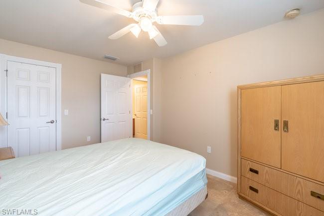 8623 Erice Court Naples, FL 34114 - Photo 27 of 37 a bedroom with a bed and a chandelier