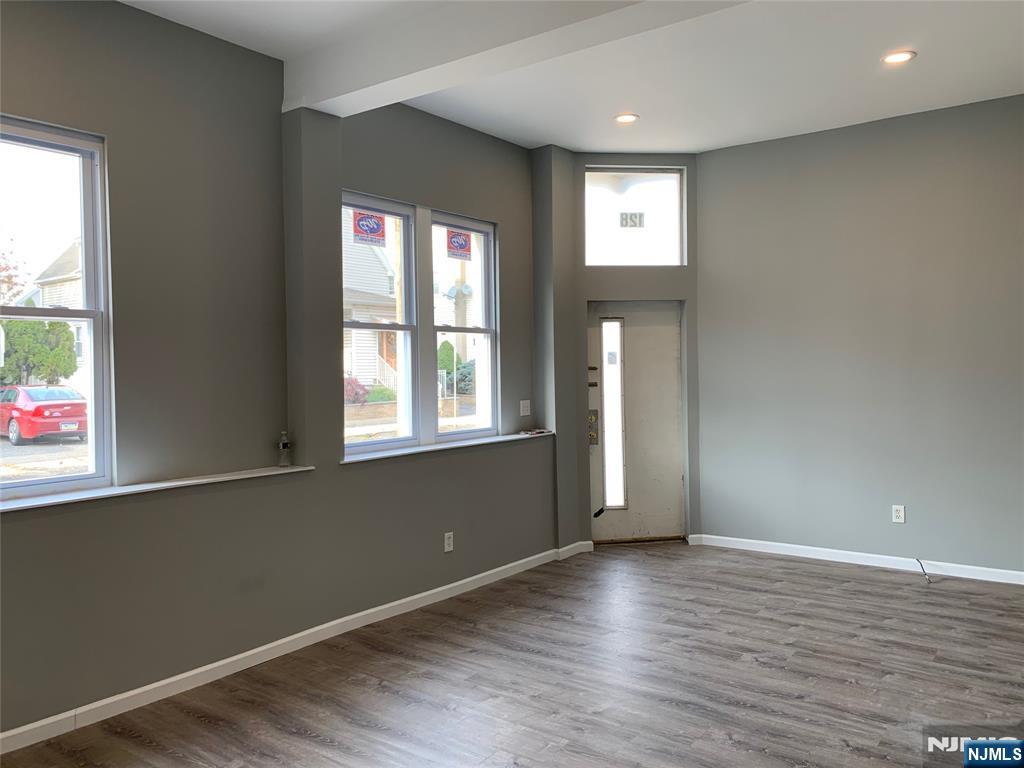 128 Locust Avenue, Unit A Wallington, NJ 07057 - Photo 11 of 13 an empty room with wooden floor and windows