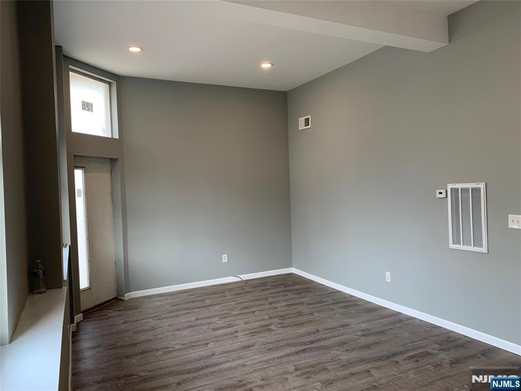 128 Locust Avenue, Unit A Wallington, NJ 07057 - Photo 12 of 13 a view of an empty room with wooden floor and a window