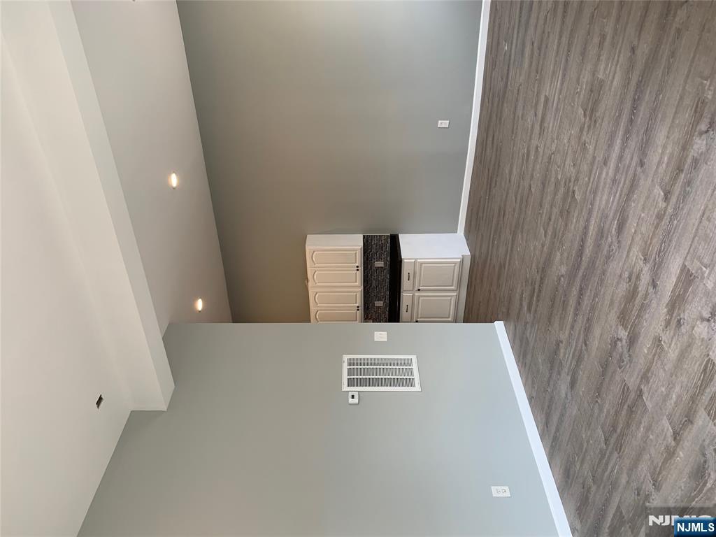 128 Locust Avenue, Unit A Wallington, NJ 07057 - Photo 3 of 13 a view of an empty room with wooden floor and a window