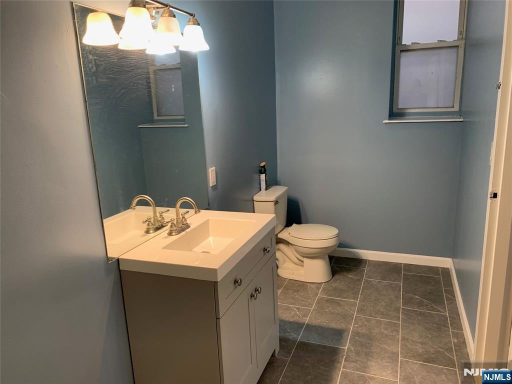 128 Locust Avenue, Unit A Wallington, NJ 07057 - Photo 8 of 13 a bathroom with a sink and a toilet