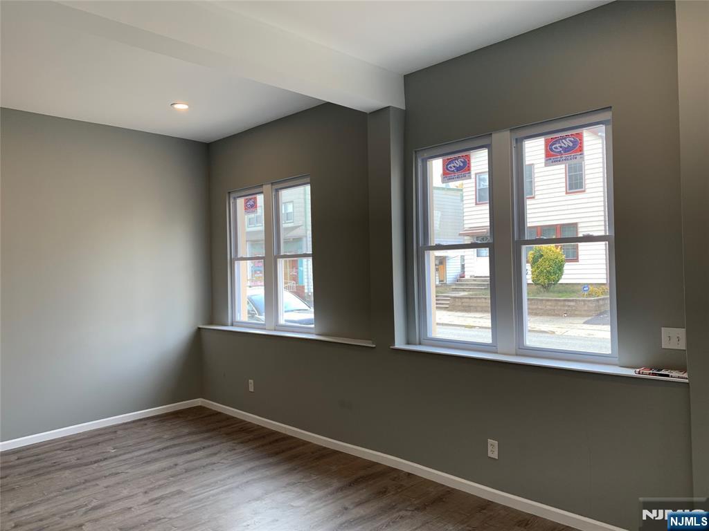 128 Locust Avenue, Unit A Wallington, NJ 07057 - Photo 10 of 13 an empty room with wooden floor and windows