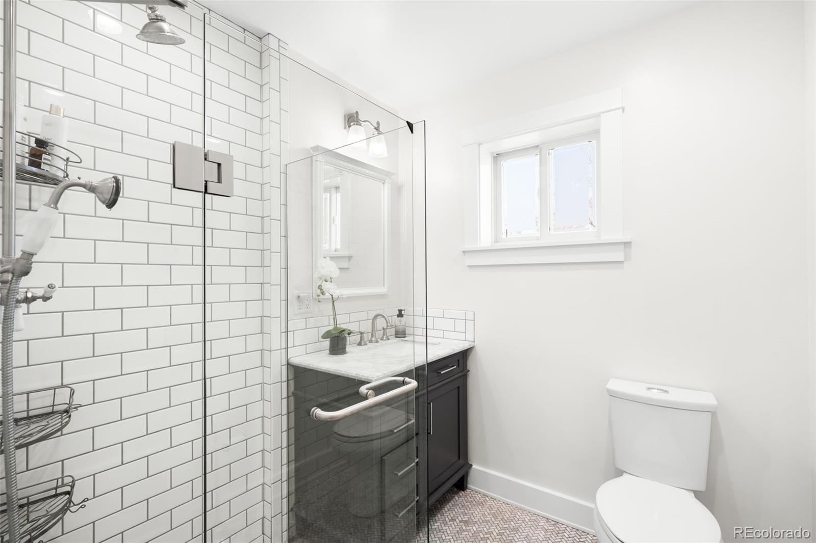 1032 Hooker Street Denver, CO 80204 - Photo 12 of 31 a bathroom with a sink toilet and shower