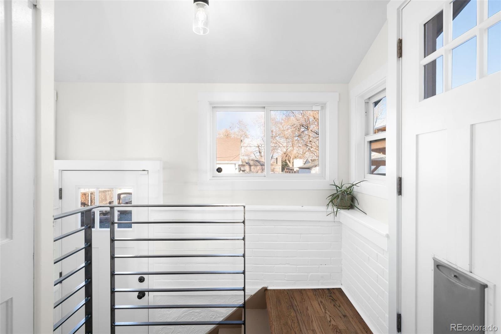 1032 Hooker Street Denver, CO 80204 - Photo 13 of 31 a bathroom with a bathtub and a window