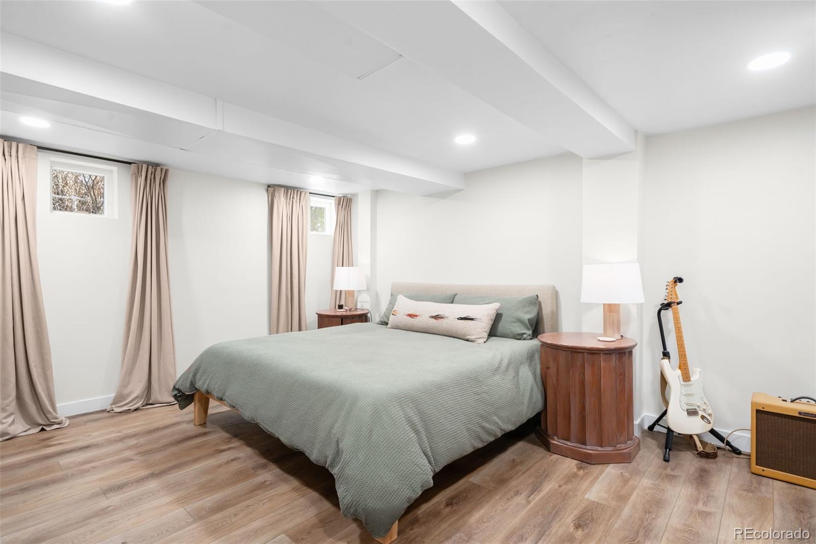 1032 Hooker Street Denver, CO 80204 - Photo 16 of 31 a bedroom with a bed and wooden floor