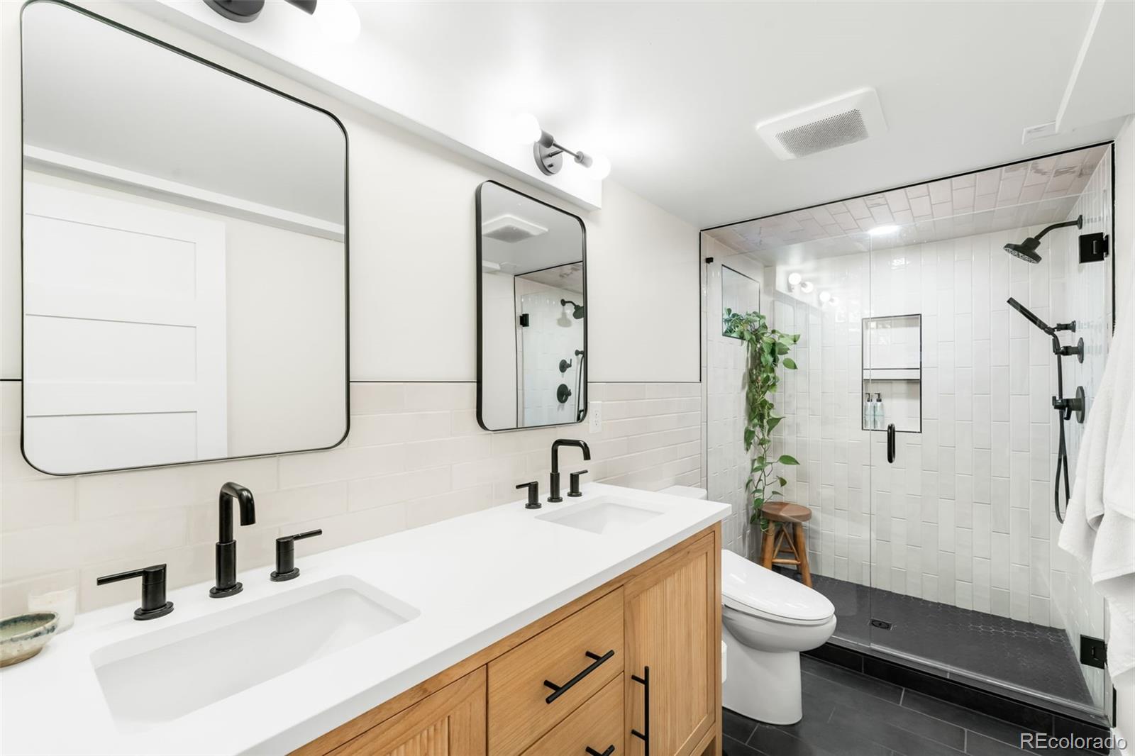 1032 Hooker Street Denver, CO 80204 - Photo 19 of 31 a bathroom with a double vanity sink toilet and shower