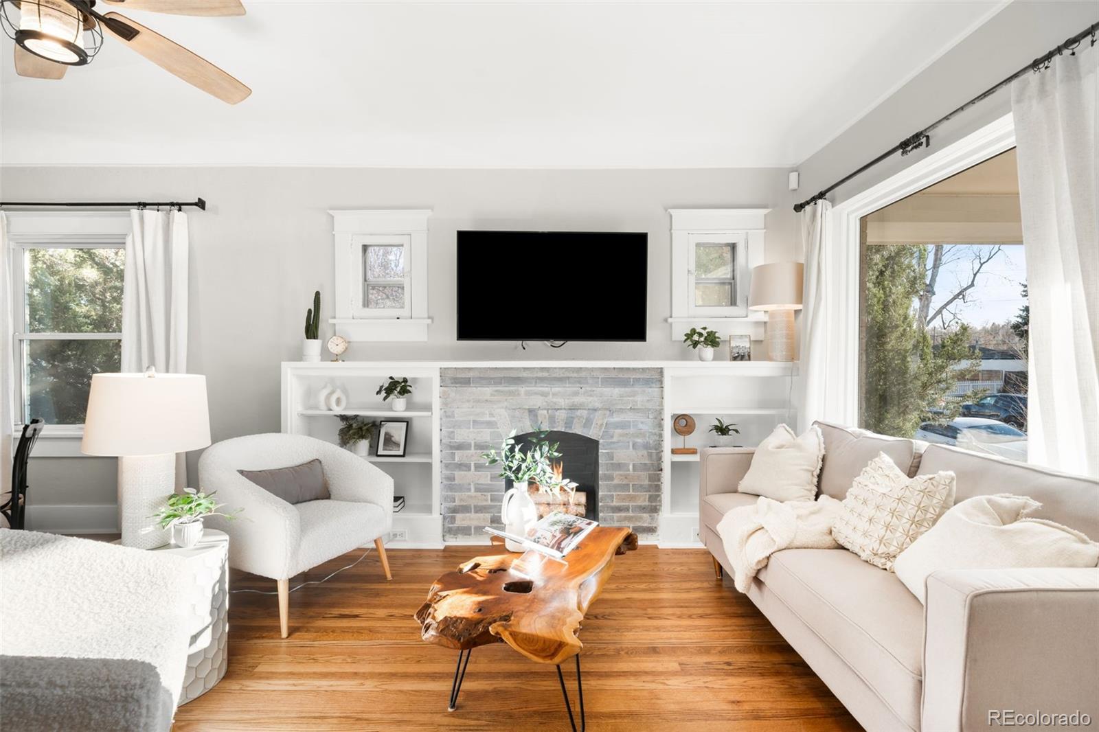 1032 Hooker Street Denver, CO 80204 - Photo 3 of 31 a living room with furniture a fireplace and a flat screen tv