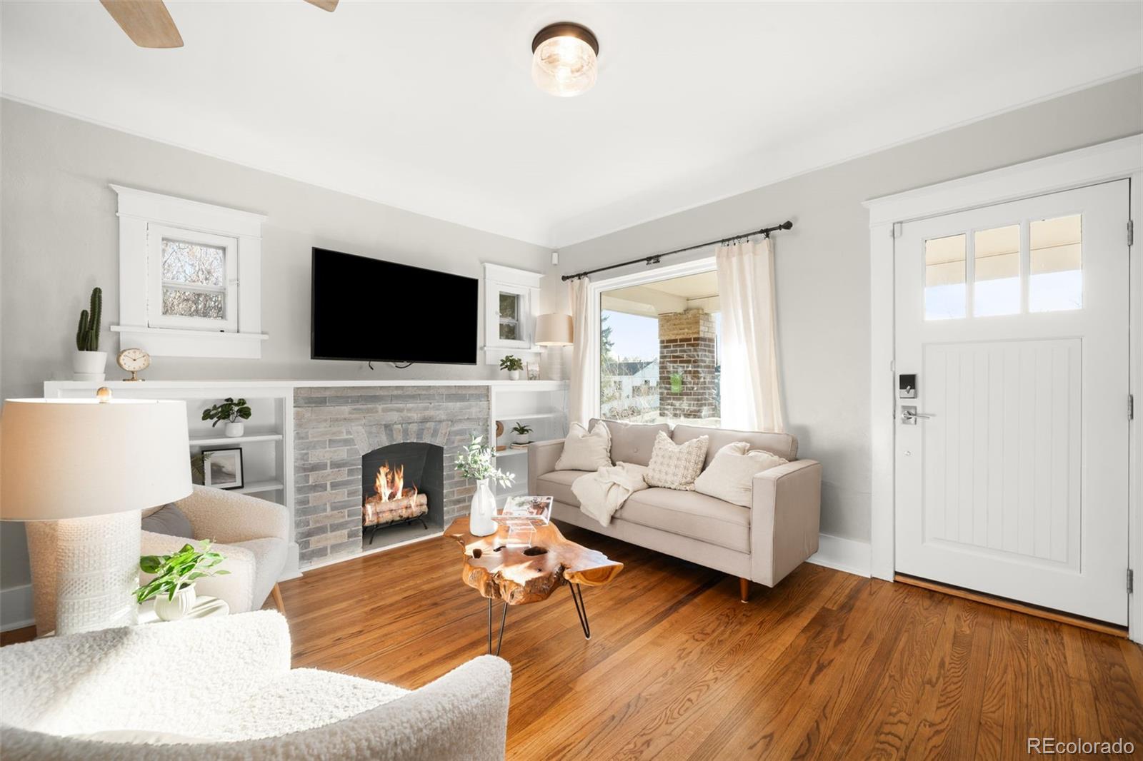 1032 Hooker Street Denver, CO 80204 - Photo 4 of 31 a living room with furniture a fireplace and a flat screen tv