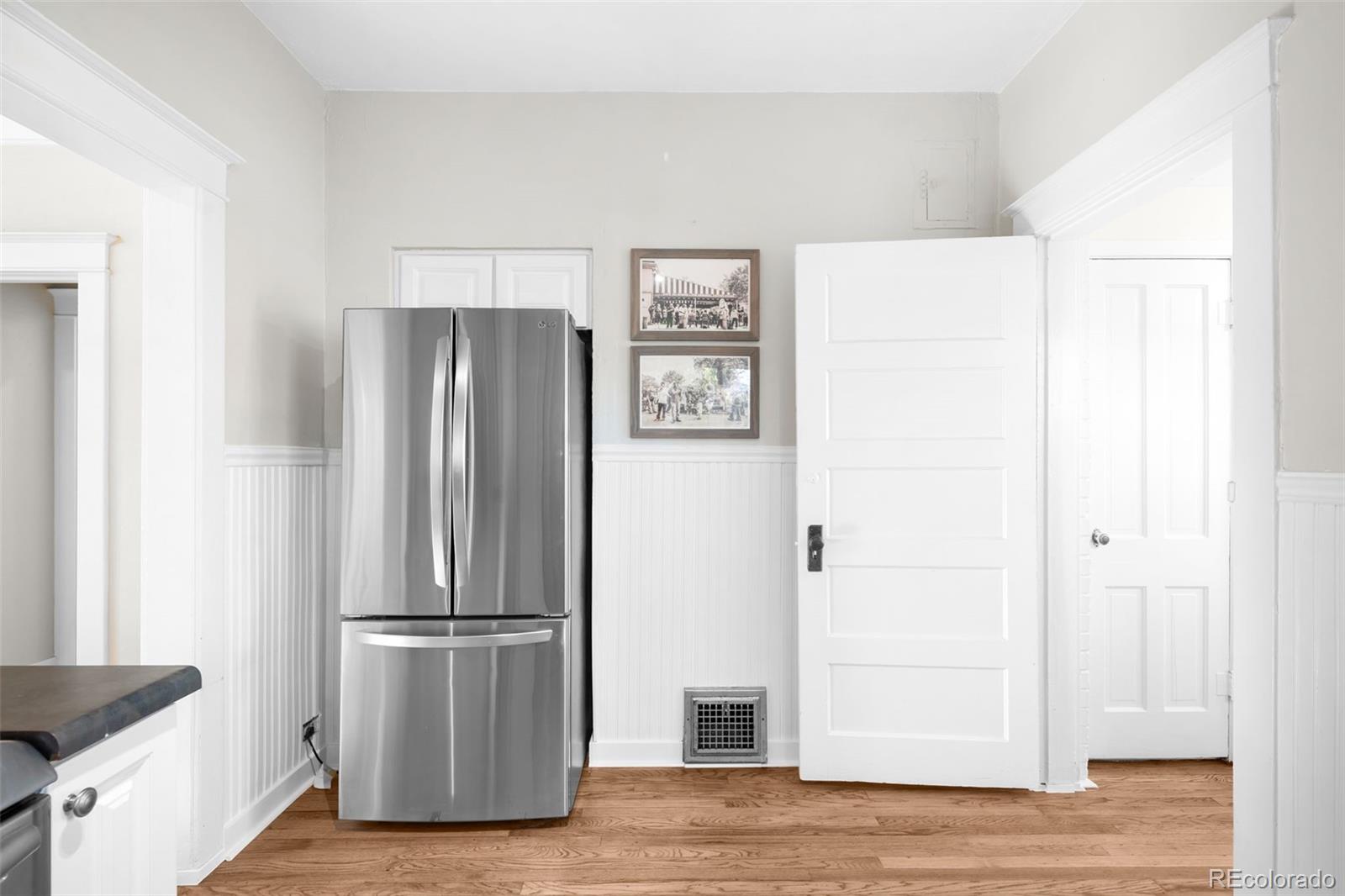 1032 Hooker Street Denver, CO 80204 - Photo 9 of 31 a view of a kitchen with refrigerator and wooden floor