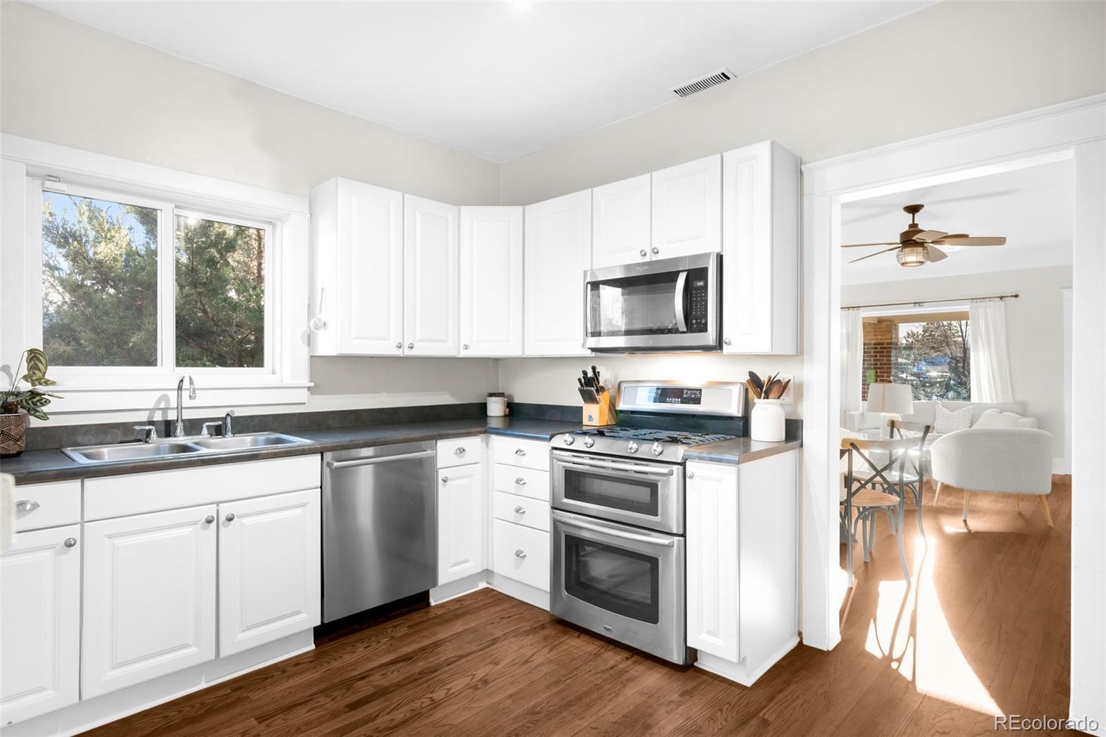 1032 Hooker Street Denver, CO 80204 - Photo 10 of 31 a kitchen with a sink stove and microwave