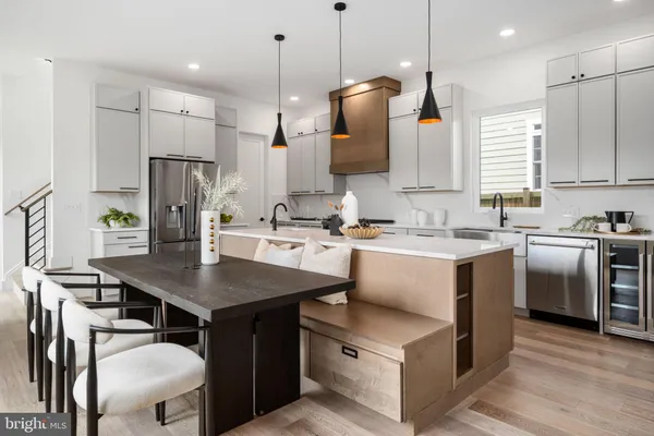 a kitchen with a sink a counter top space stainless steel appliances and cabinets