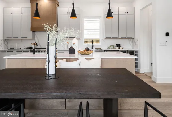 a kitchen with kitchen island stainless steel appliances a sink stove and cabinets