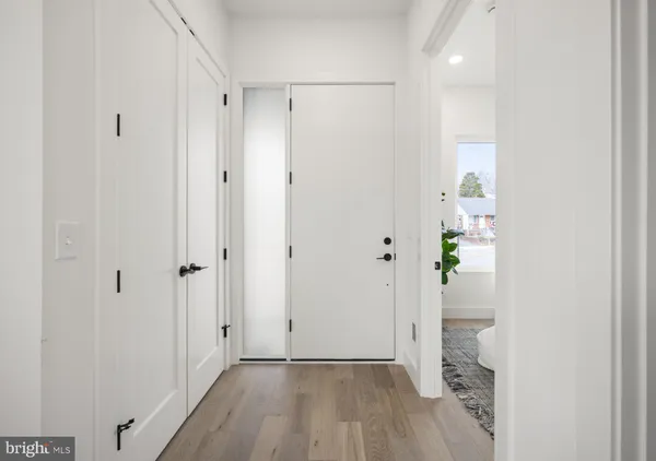 a view of a hallway with wooden floor