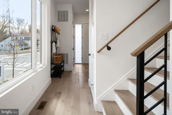 a view of an entryway with wooden floor and windows