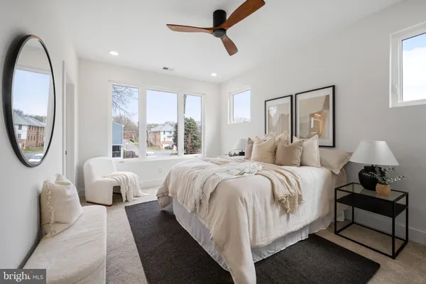 a bedroom with a large bed and a window