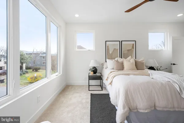 a bedroom with a bed and a large window