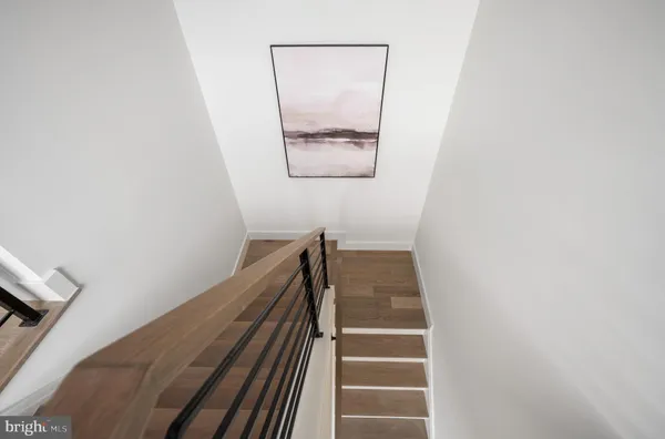 a view of staircase with wooden floor