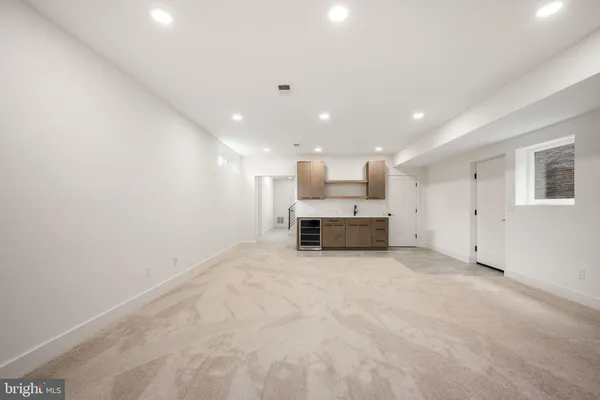 a view of a kitchen with a sink and a large window