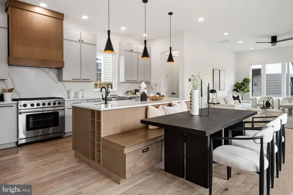 a kitchen with kitchen island granite countertop a sink a stove and a refrigerator