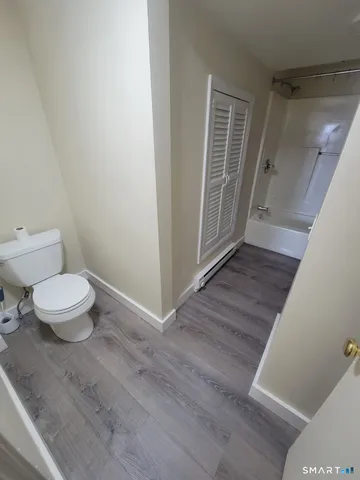 a bathroom with a toilet and a shower