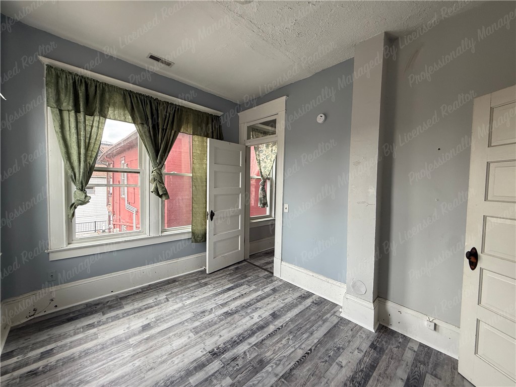 44 West High Street, Unit D Springfield, OH 45502 - Photo 13 of 25 This bright room features a clean layout, offering a versatile space for various needs.