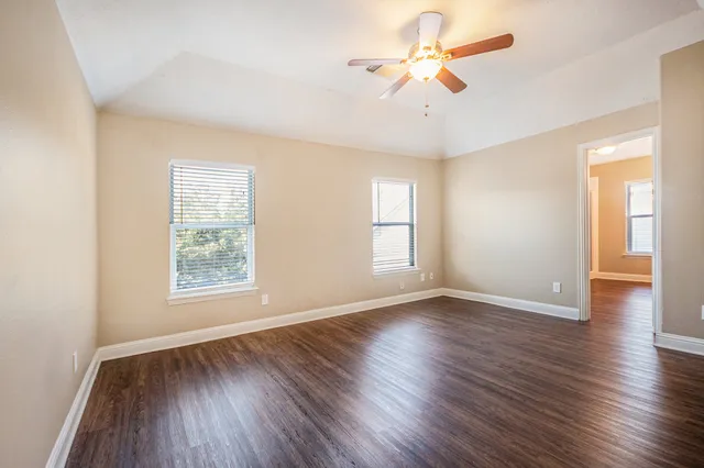 wooden floor in an empty room with a window