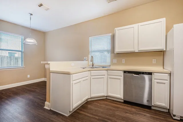a kitchen with stainless steel appliances granite countertop a sink and cabinets