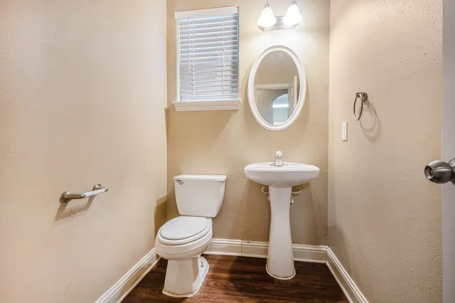a bathroom with a toilet sink and a mirror